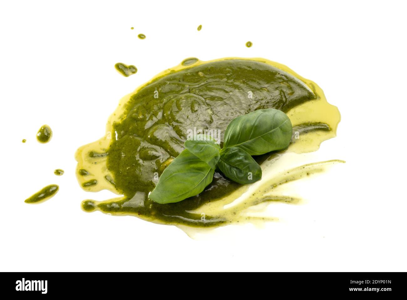 Pesto spalmato su fondo bianco, tipico sugo genovese e ligure, con foglie di basilico fresco verde e olio extravergine d'oliva Foto Stock