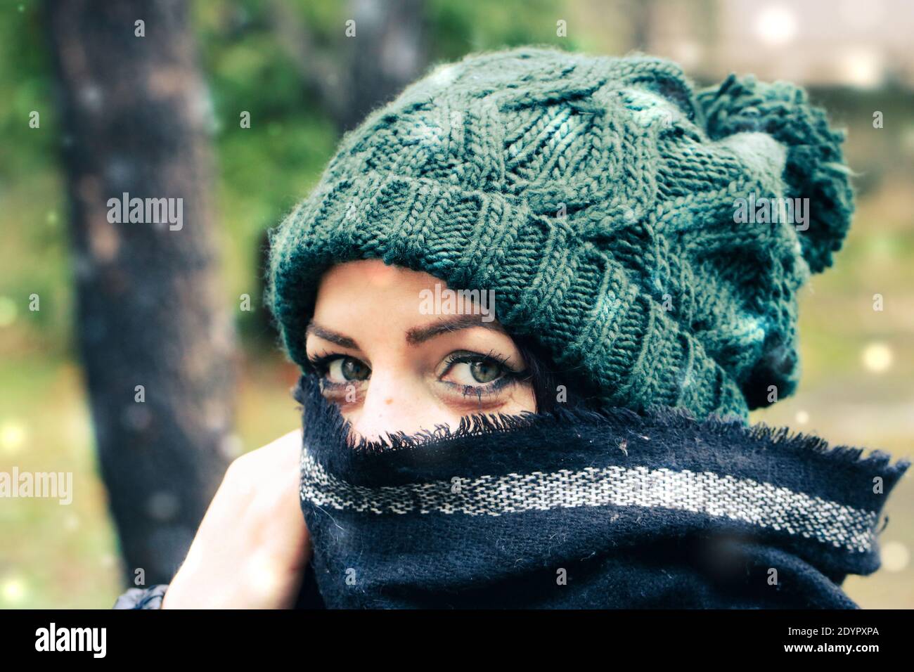 Una donna nella neve che indossa un cappello a maglia Foto Stock