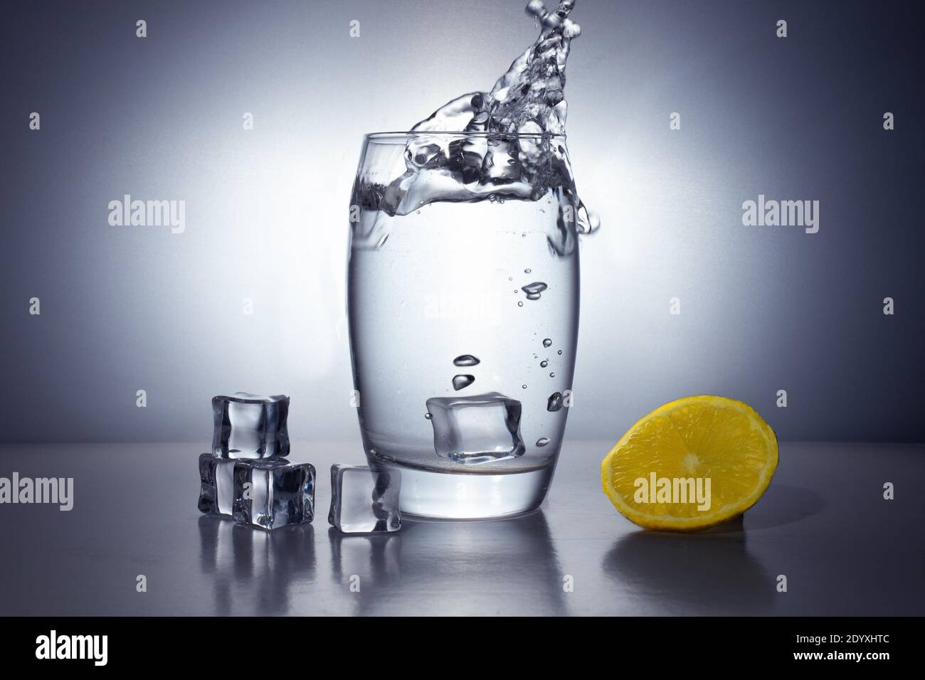 Un bicchiere d'acqua, limone e ghiaccio. Spruzzi d'acqua, tempesta in un  bicchiere d'acqua. Sfondo sfumato bianco e nero rotondo Foto stock - Alamy