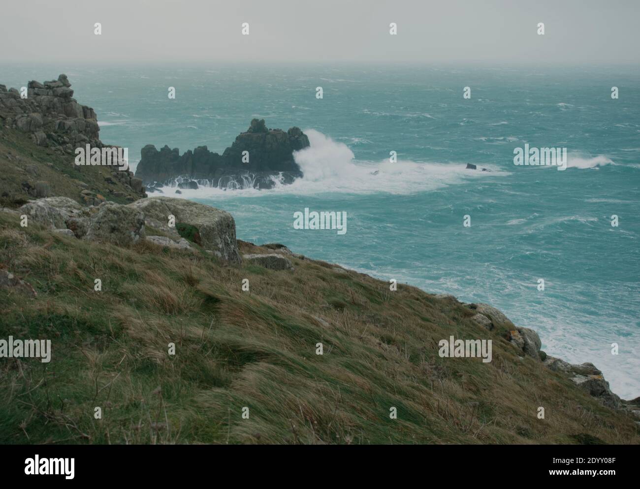 Mari burrasdi e onde dell'oceano Atlantico che si infrangono sulle rocce a Lands End Cornwall, Regno Unito dopo che i venti della forza delle balle di Storm Bella si propagano attraverso la costa Foto Stock