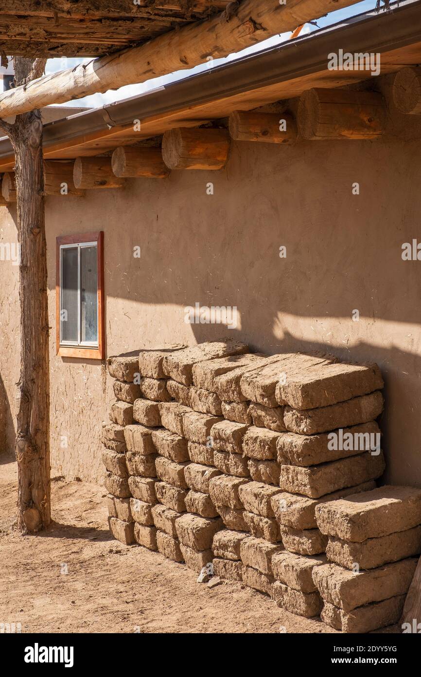 Mattoni di fango di Adobe accatastati accanto a una casa di adobe nello storico villaggio nativo americano di Taos Pueblo, New Mexico, Stati Uniti. Un sito patrimonio dell'umanità dell'UNESCO Foto Stock