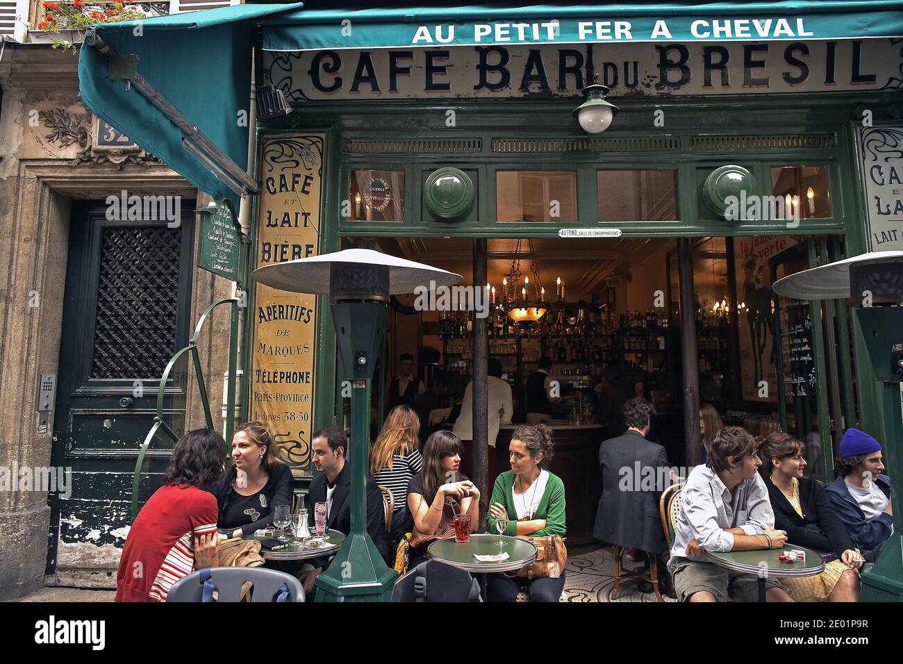 FRANCIA / IIe-de-France/Paris/ le Marais/ Peopel seduta fuori Au Petit Fer à Cheval. Foto Stock