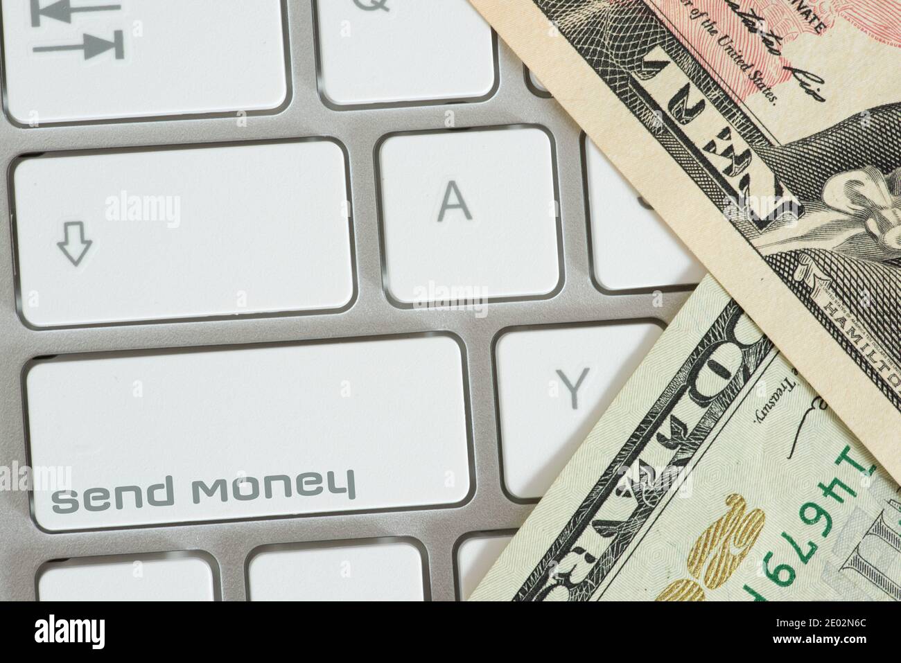 Un computer, bollette del dollaro e pulsante inviare denaro Foto Stock