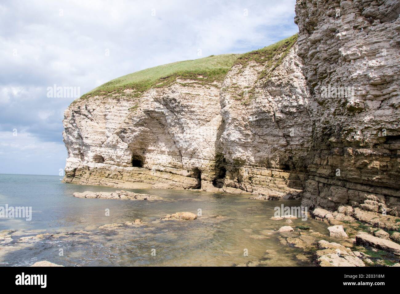 Le grotte scarpano le morbide scogliere di gesso a Flamborough Cliffs & Landing Nord Foto Stock