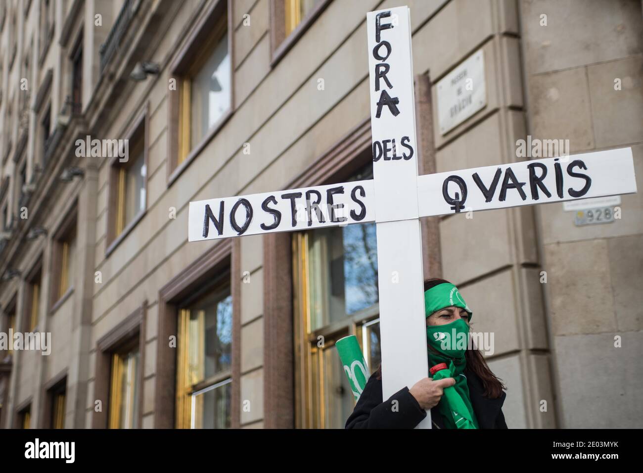 Un manifestante che porta una croce durante la manifestazione.il movimento argentino, Green Tide (Marea Verde) fa una chiamata di fronte al consolato argentino a Barcellona, il giorno in cui il Senato argentino discute di dare la sanzione finale ad una legge che permette l'interruzione volontaria della gravidanza. Foto Stock