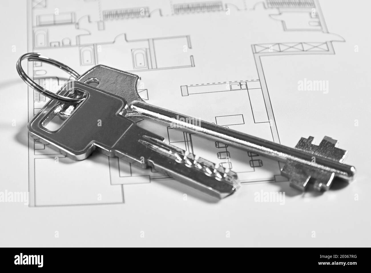 Le chiavi metalliche sulla disposizione dell'appartamento come concetto di affari immobiliari. Vendita di immobili e immobili Foto Stock