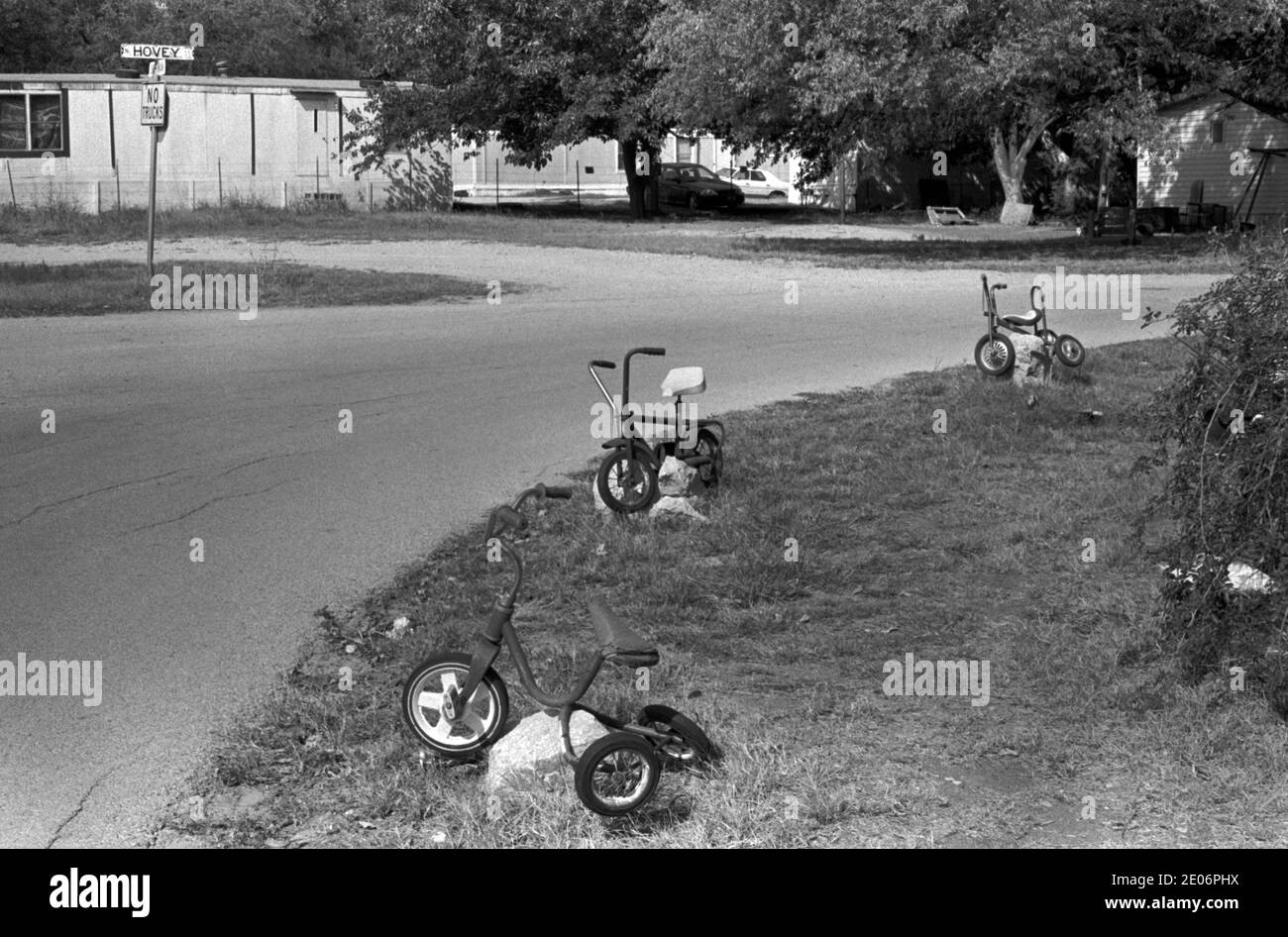 Strada suburbana in una piccola città America, insolita decorazione giardino unico utilizzando tricicli bambini 1999 Cico Texas USA 1990 OMERO SYKES Foto Stock