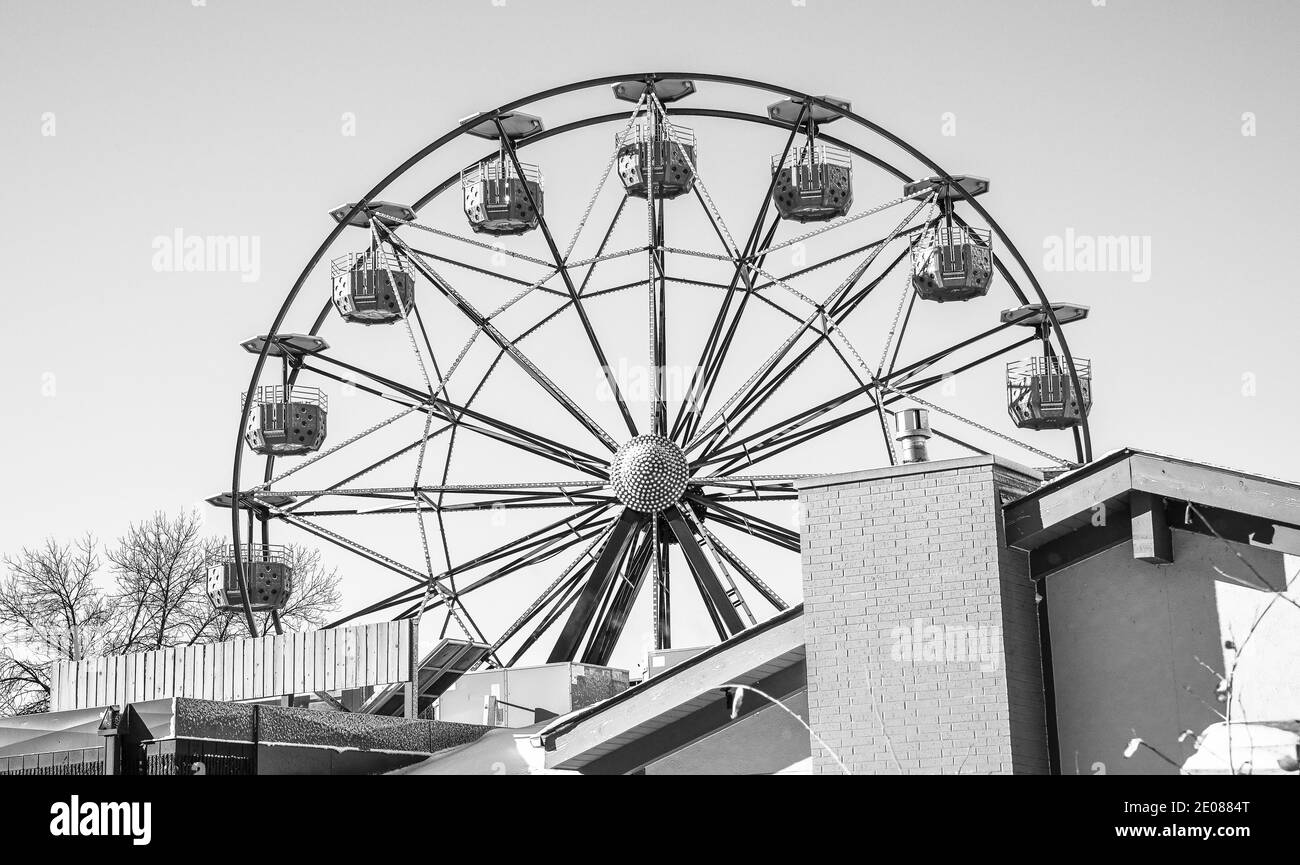 Giro vuoto nel parco divertimenti ruota panoramica in inverno contro cielo blu Foto Stock