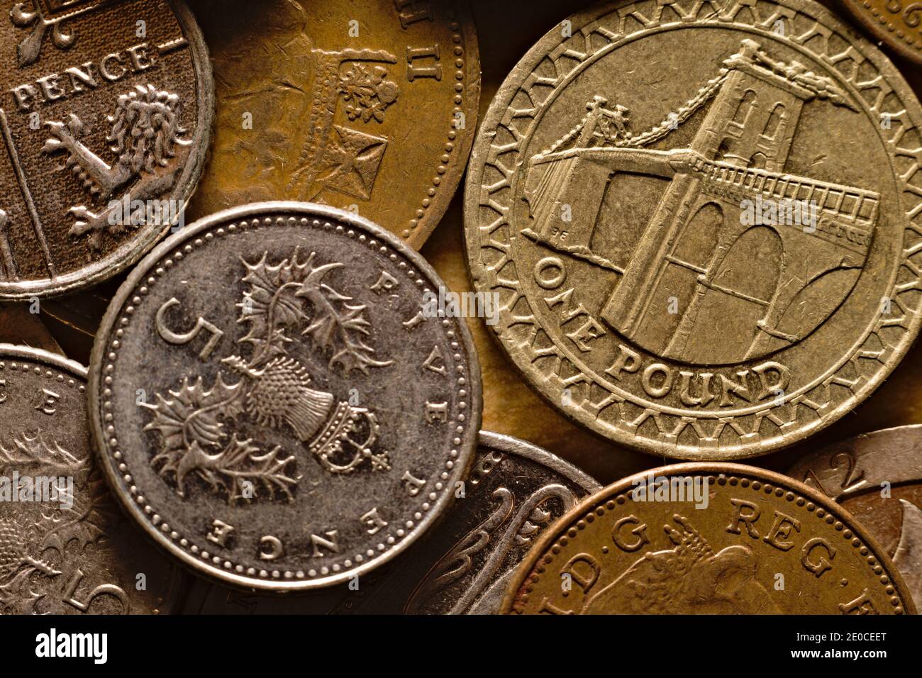 Usato UK cinque pence moneta su una pila di assortiti GBP valuta contanti Foto Stock