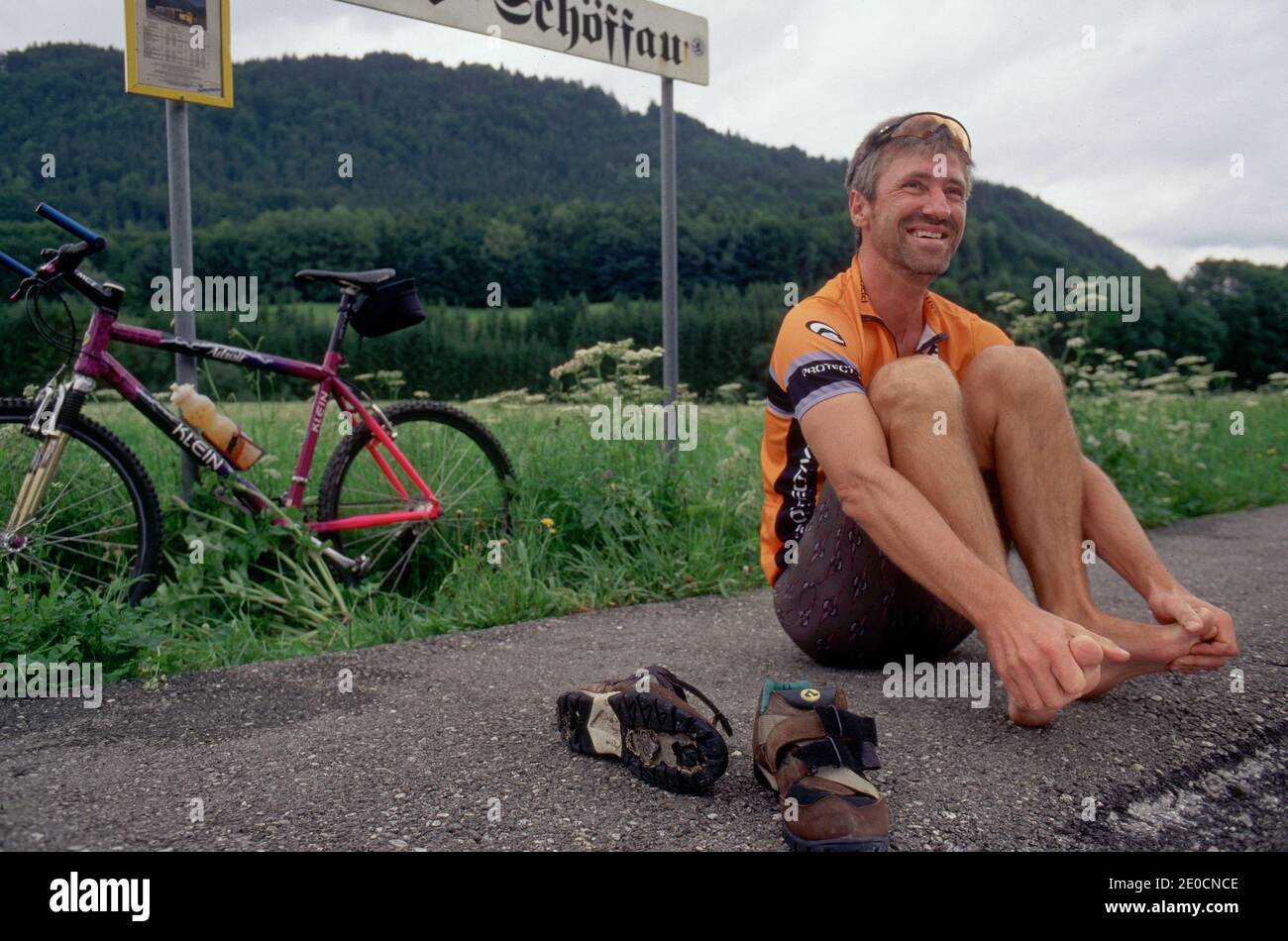 Uomo con mountain bike avendo un Rest.Man con bicicletta godendo natura e paesaggio di montagna in estate, attività all'aperto Foto Stock