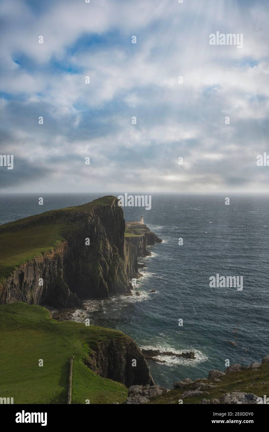 Incredibile vista aerea remota del faro di Neist Point situato su scogliera rocciosa verde di fronte al mare calmo sul sole Giorno in Scozia Foto Stock