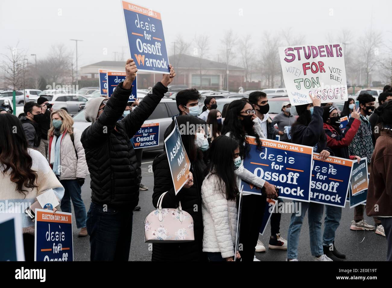 Suwanee, Georgia, Stati Uniti. 31 dicembre 2020. I sostenitori del candidato del Senato democratico Jon Ossoff tengono i segni che leggono DESIS PER OSSOFF WARNOCK e GLI STUDENTI PER JON OSSOFF VOTA BLU!! In un Islander Asiatico Americano e Pacifico incontratevi e salutate a Suwanee, GA. L'evento si è svolto l'ultimo giorno delle prime votazioni per le elezioni del Senato in Georgia, dove il candidato democratico Jon Ossoff sta correndo contro il repubblicano David Perdue. Credit: John Arthur Brown/ZUMA Wire/Alamy Live News Foto Stock