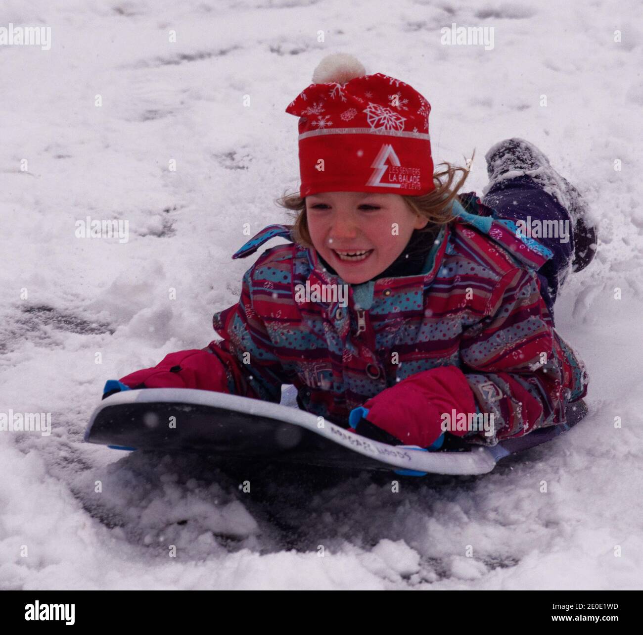 Una bambina (6 anni) Slitta in inverno in Quebec Foto Stock