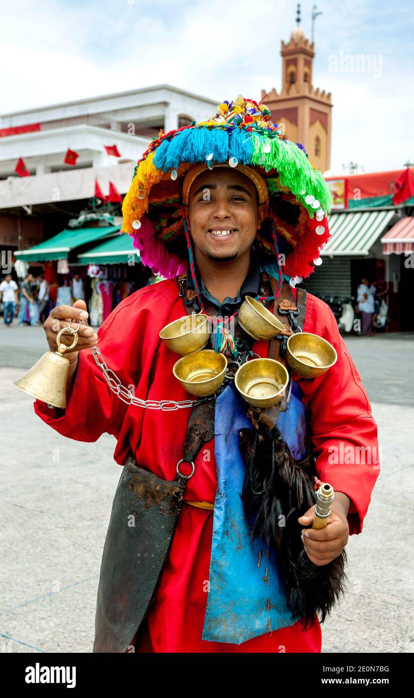 Un uomo che vende tè da un vaso tradizionale a Djemaa el-Fna, la piazza principale della medina di Marrakech in Marocco. Foto Stock