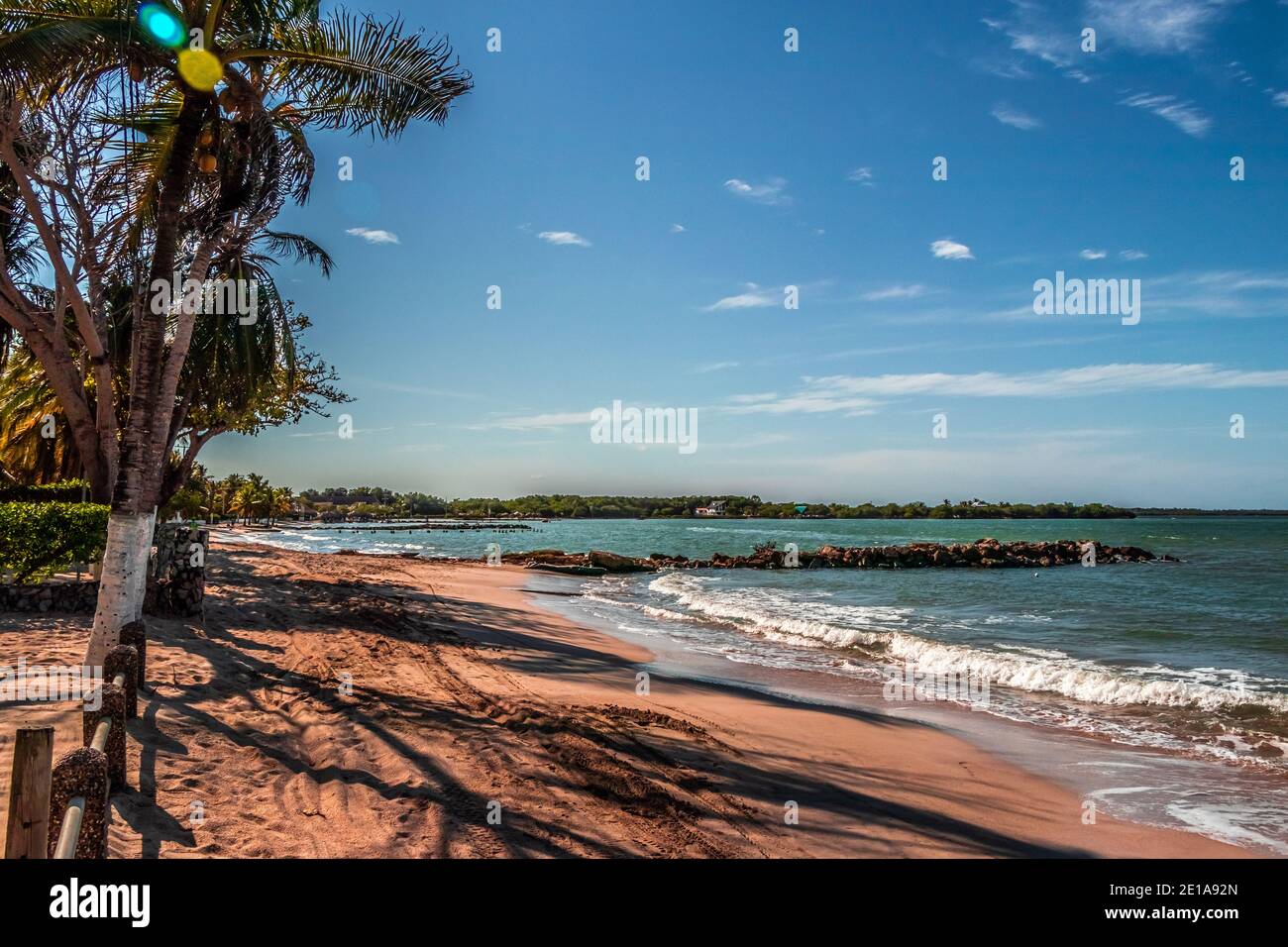 Una bella vista di un paesaggio tropicale spiaggia, il sole sta appena sorgendo in un'alba meravigliosa e colorata Foto Stock