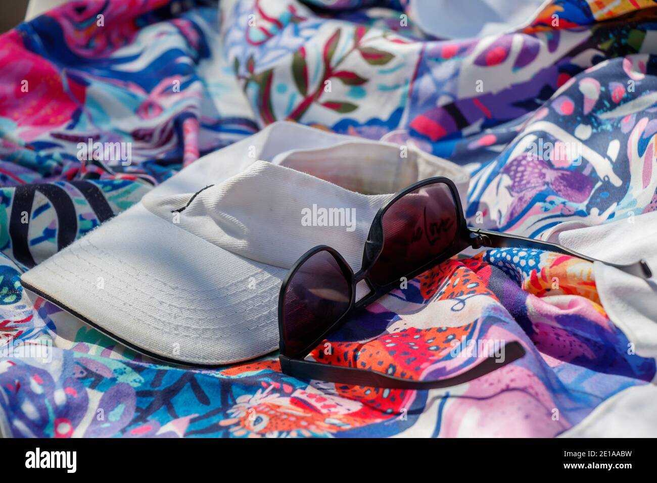 Alcune donne hanno lasciato i suoi accessori estivi, un cappuccio, un paio di occhiali da sole e un fazzoletto, una scena colorata Foto Stock