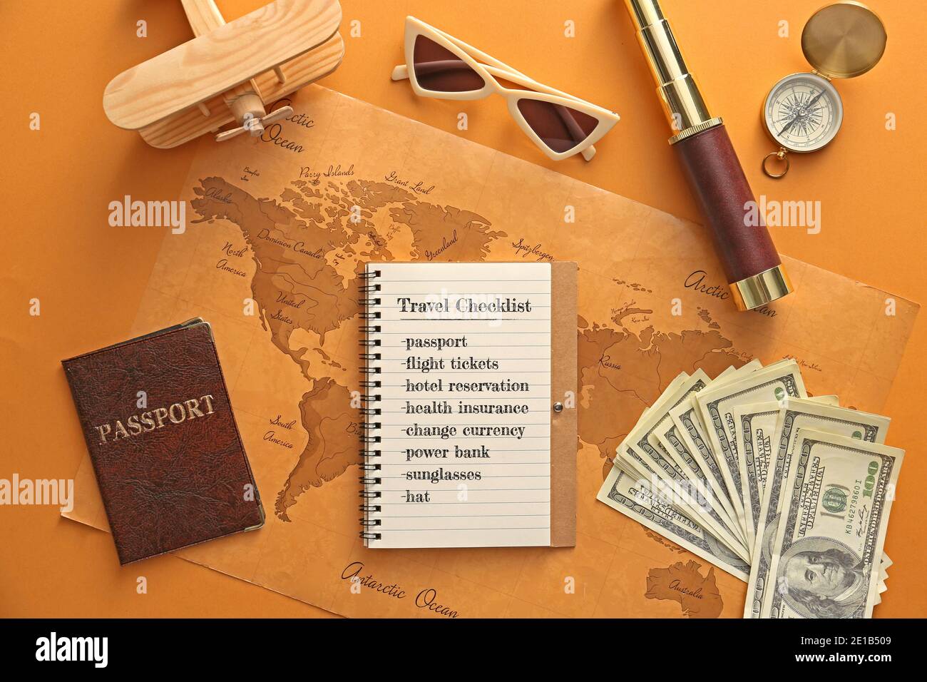 Notebook con elenco di controllo delle operazioni da eseguire prima di viaggiare e mappa del mondo su sfondo a colori Foto Stock