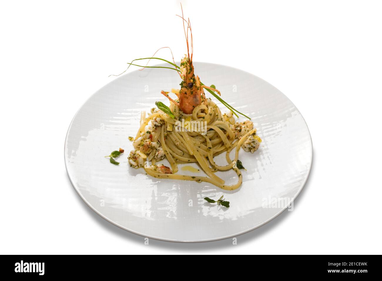 Linguine con polpa di gamberi, tipica pasta di spaghetti italiana con frutti di mare in piatto bianco isolato su fondo bianco Foto Stock
