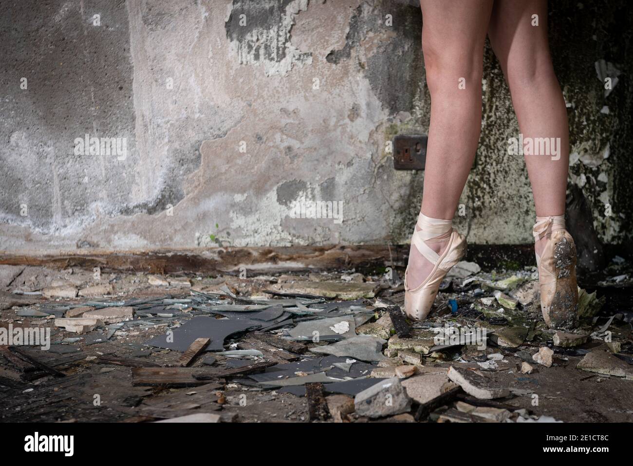 Closeup di piedi ballerina su punta in scarpe da ballo in un luogo abbandonato Foto Stock