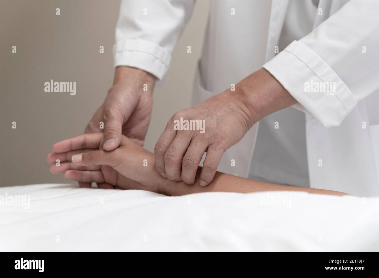 un medico prende il polso di un paziente sul polso Foto Stock