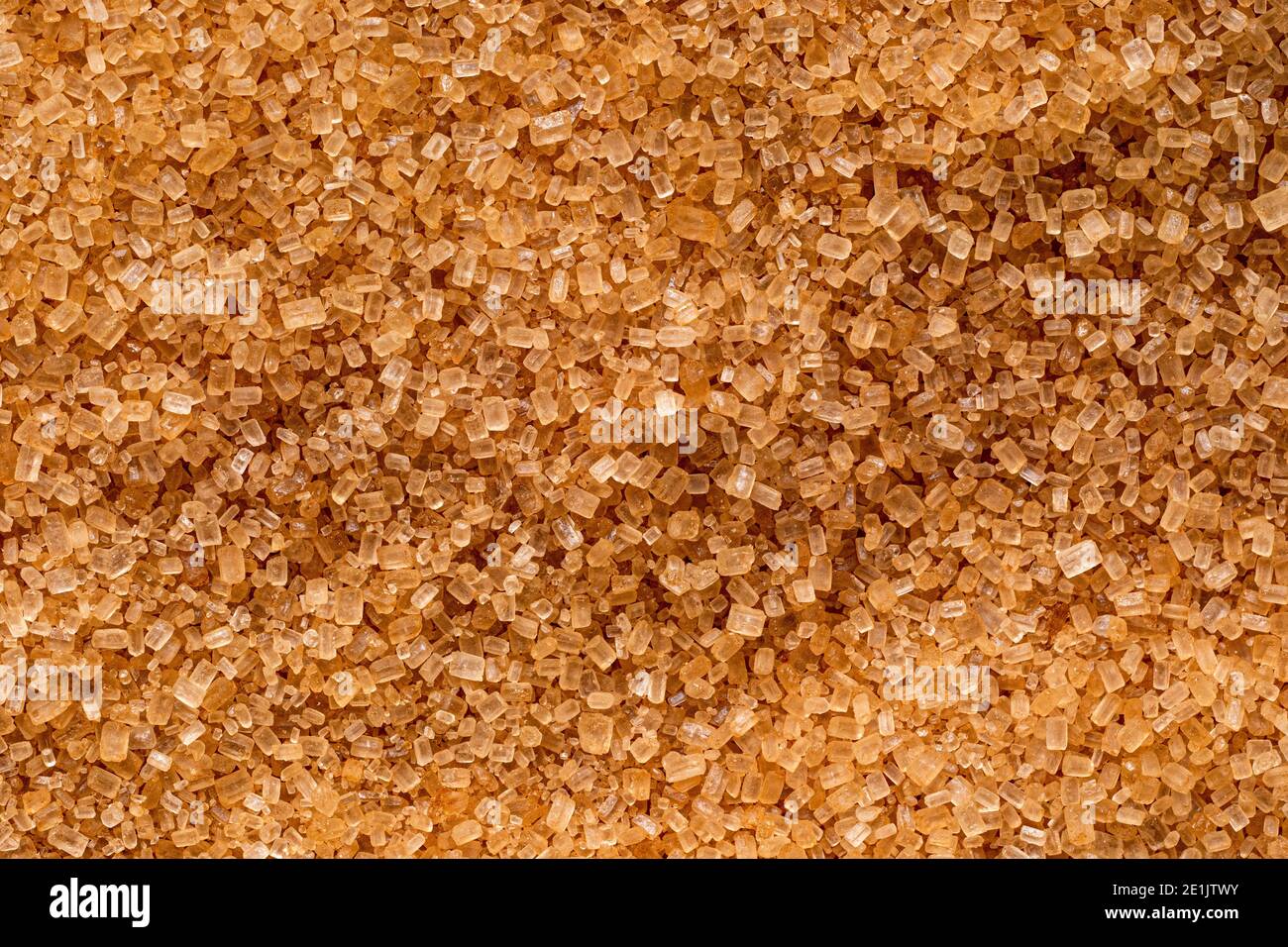 Sfondo di zucchero di canna chiaro granulato. Foto Stock