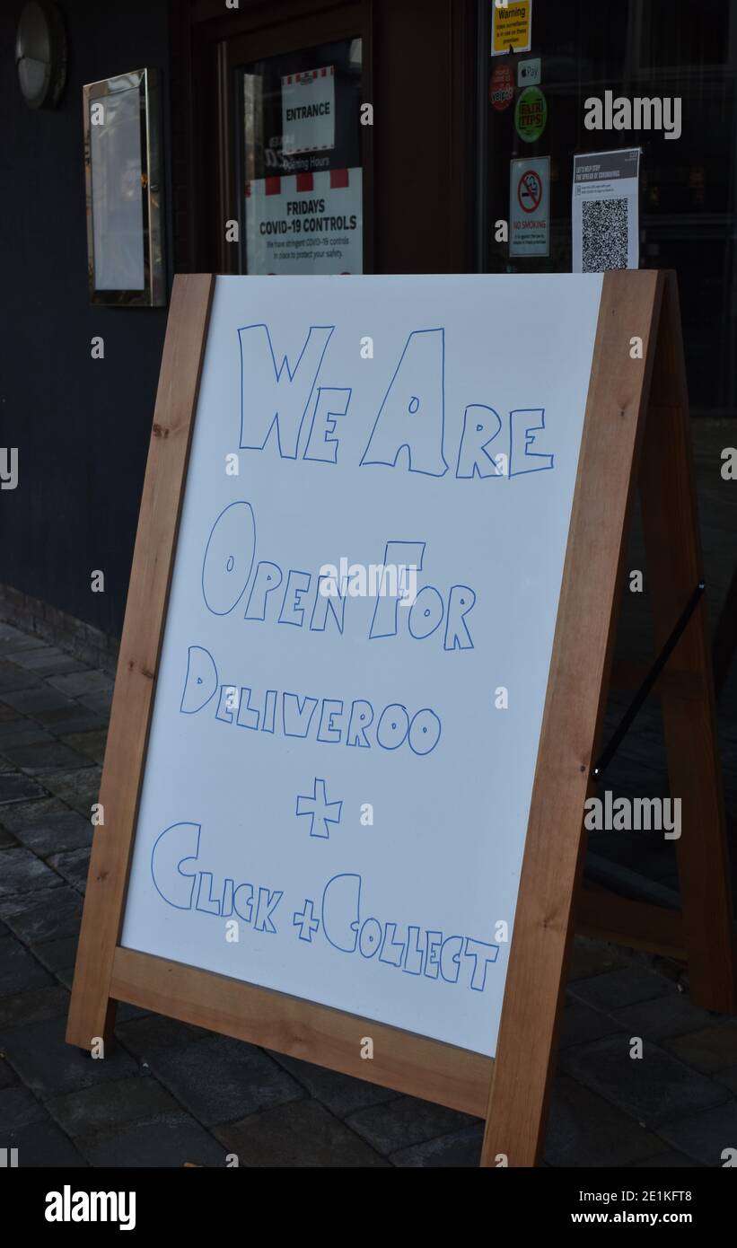 Firma all'esterno di un ristorante che è chiuso a causa di restrizioni Covid-19, ma ancora facendo consegne e fare clic e ritirare. Foto Stock