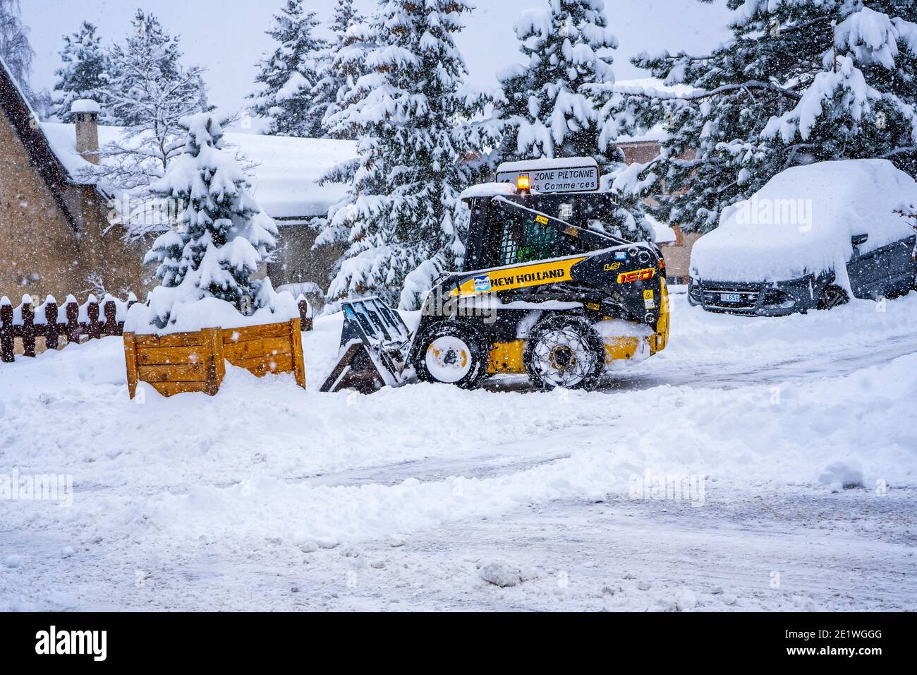 Auron, Francia 01.01.2021 pala gommata che rimuove la neve su una stazione sciistica. Eliminare la strada dalla neve. Foto di alta qualità Foto Stock