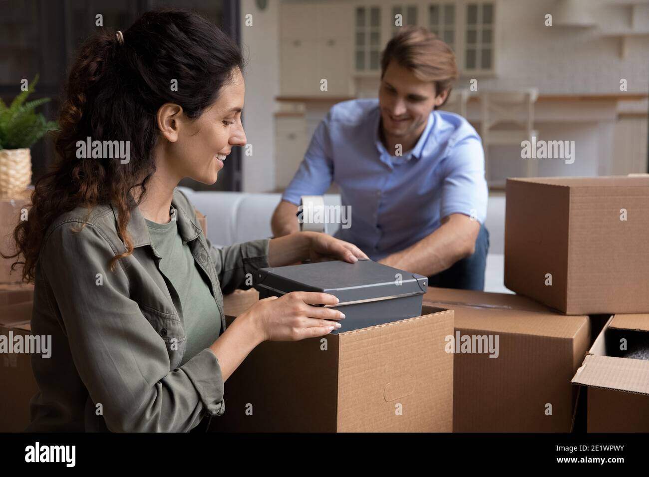 Felice coppia scatole pacchetto trasferimento a nuova casa Foto Stock