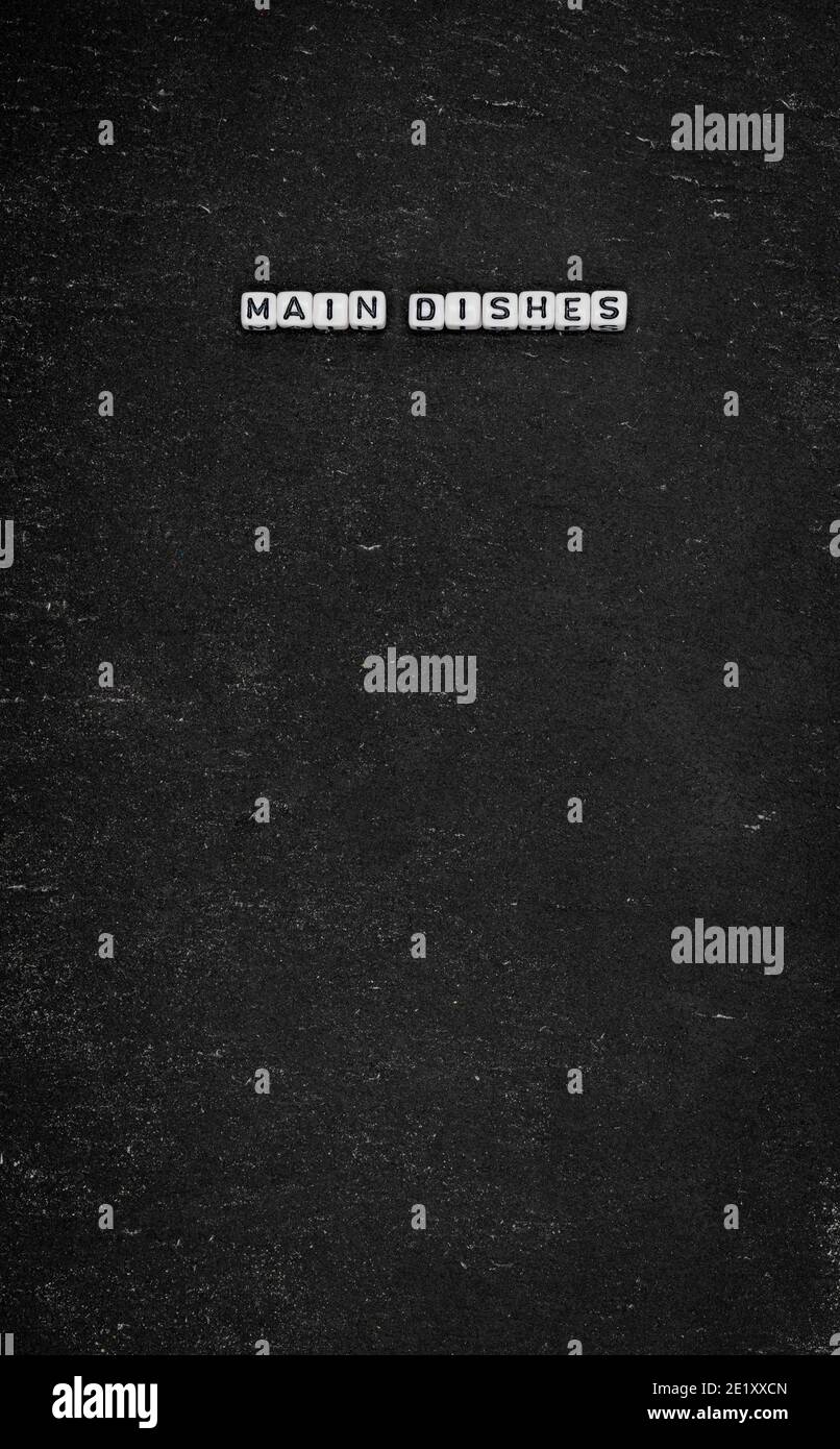 Piatti principali di parola su fondo di pietra nera Foto Stock