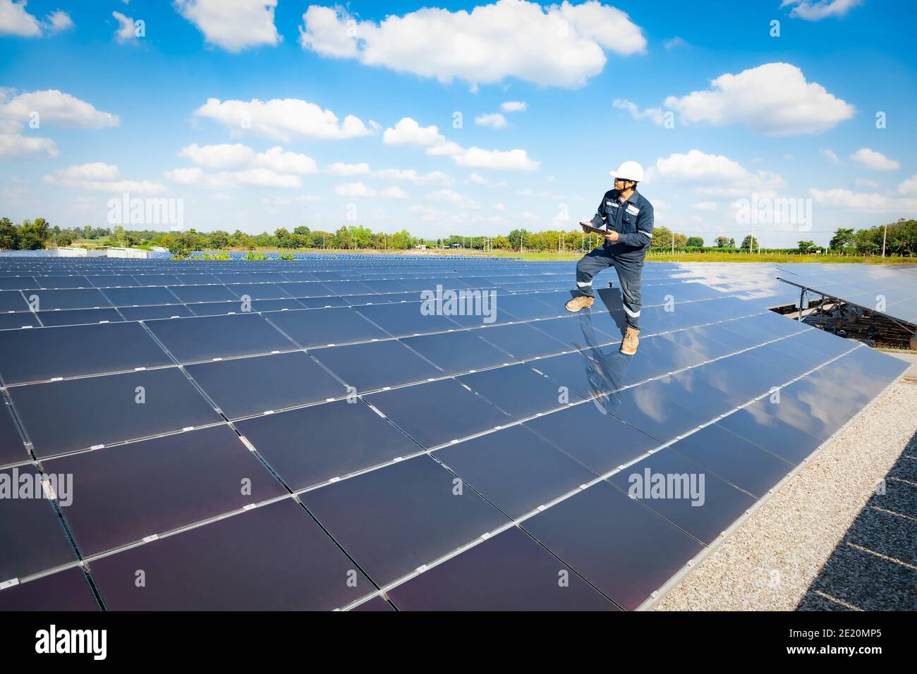 Tecnico stand su pannello solare per verificare il funzionamento dei sistemi di fattoria solare, energia alternativa per conservare il mondo è energia, Fotovoltaico mod Foto Stock Tecnico stand su pannello solare per verificare il funzionamento dei sistemi di fattoria solare, energia alternativa per conservare il mondo è energia, Fotovoltaico mod Foto Stock
