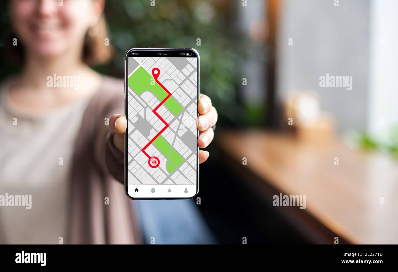 Smartphone con mappe online di navigazione GPS aperte sullo schermo in Mano femmina Foto Stock