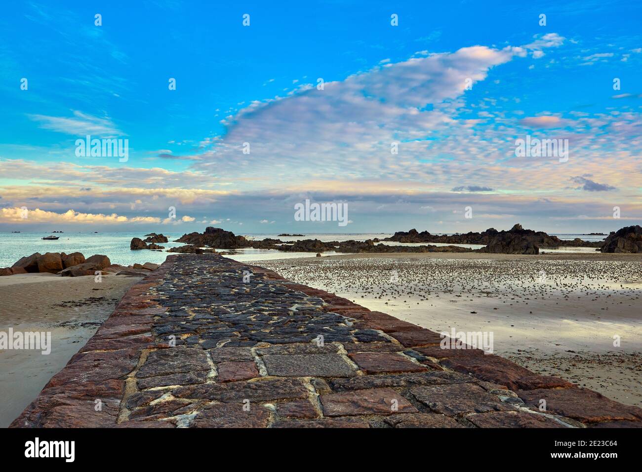 Immagine del molo in pietra a Green Island con mare calmo, spiaggia, cielo blu con couds. Jersey, Isole del canale Foto Stock