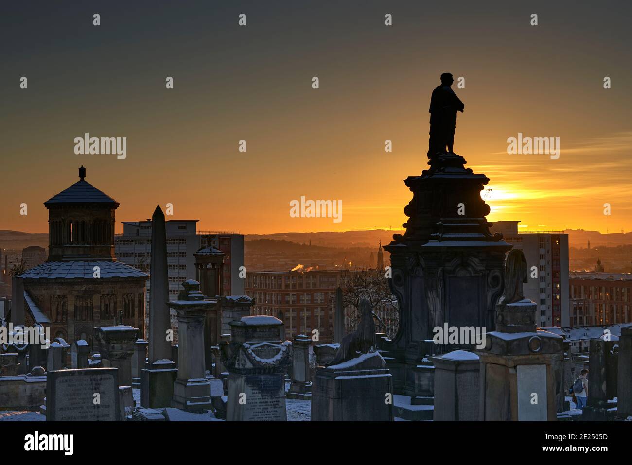 Tramonto mozzafiato sulla necropoli di Glasgow in una serata d'inverno innevata incorniciata dal Monumento a William McGavin. Foto Stock