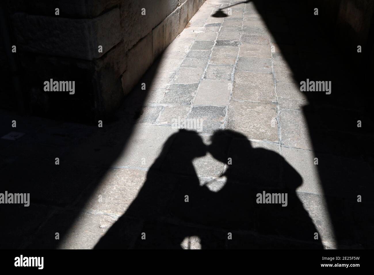 Ombra di una giovane coppia baciando per strada. Foto Stock