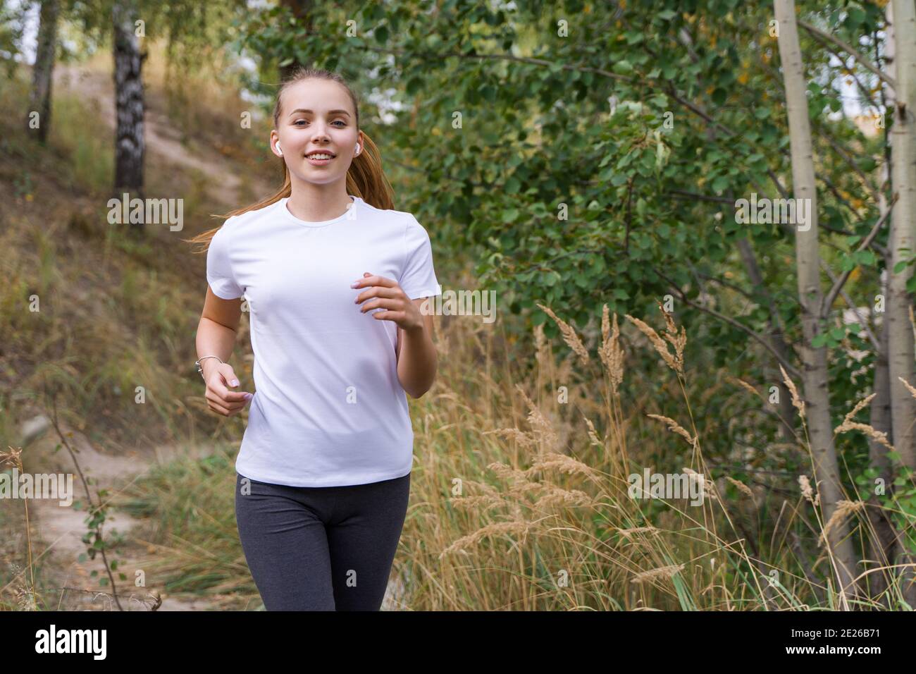 Giovane donna jogging nel parco Foto Stock