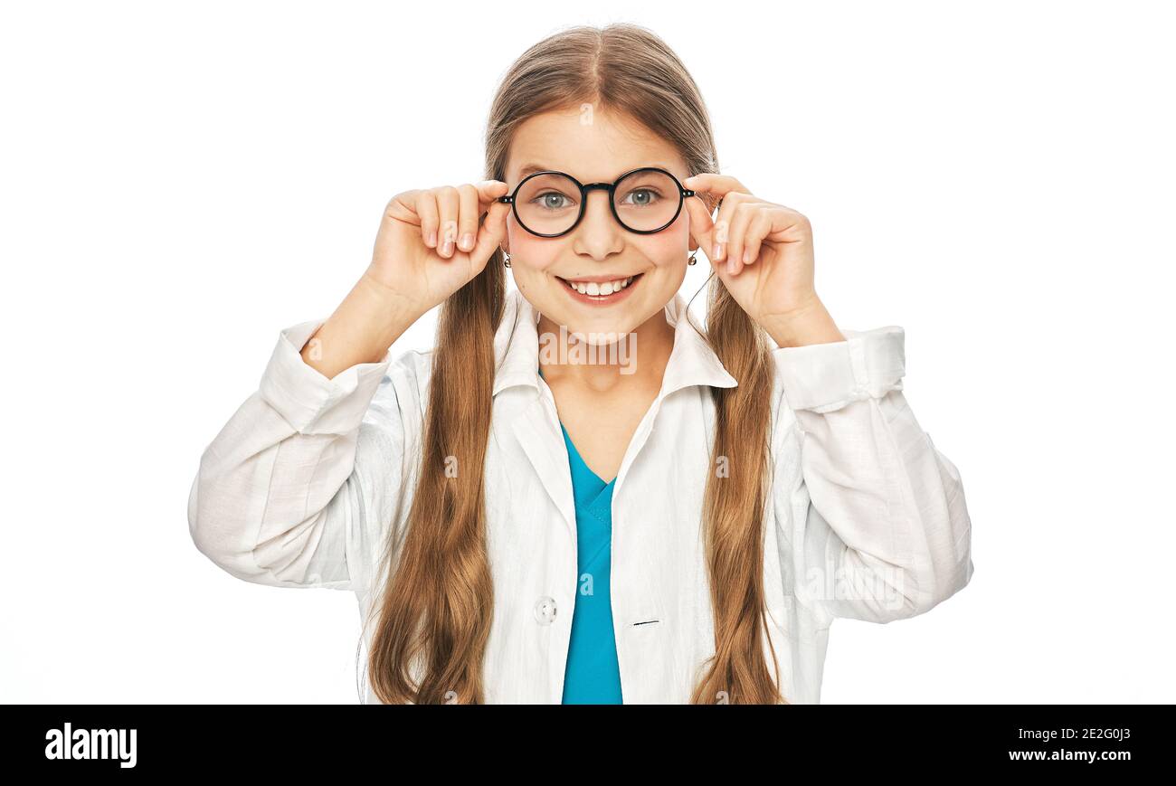 Ritratto di sorridente ragazza carina che indossa occhiali e cappotto medico. Trattamento di visione del bambino scelta degli occhiali su sfondo bianco Foto Stock