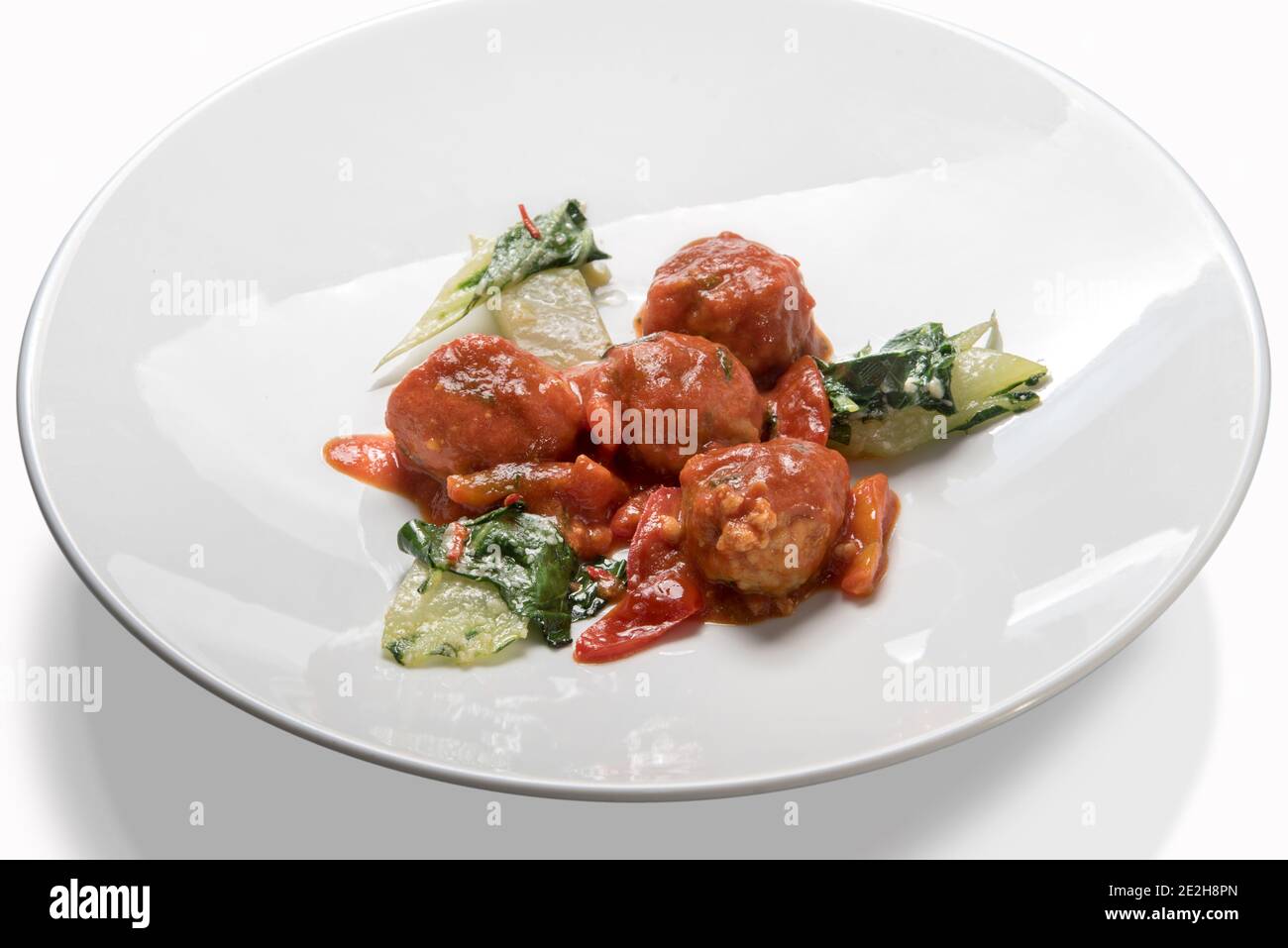 Polpette al Sugo, polpette di manzo con salsa di pomodoro e verdure in piatto bianco isolato su bianco Foto Stock