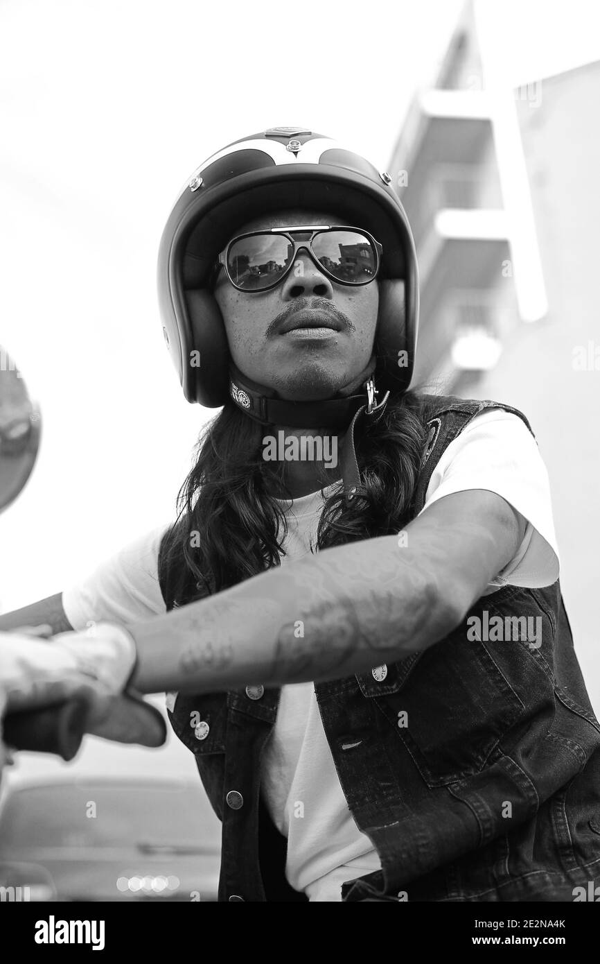 Primo piano ritratto di giovane biker, casco da moto con occhiali al festival Wheels and Waves di Biarritz, Francia. Foto Stock