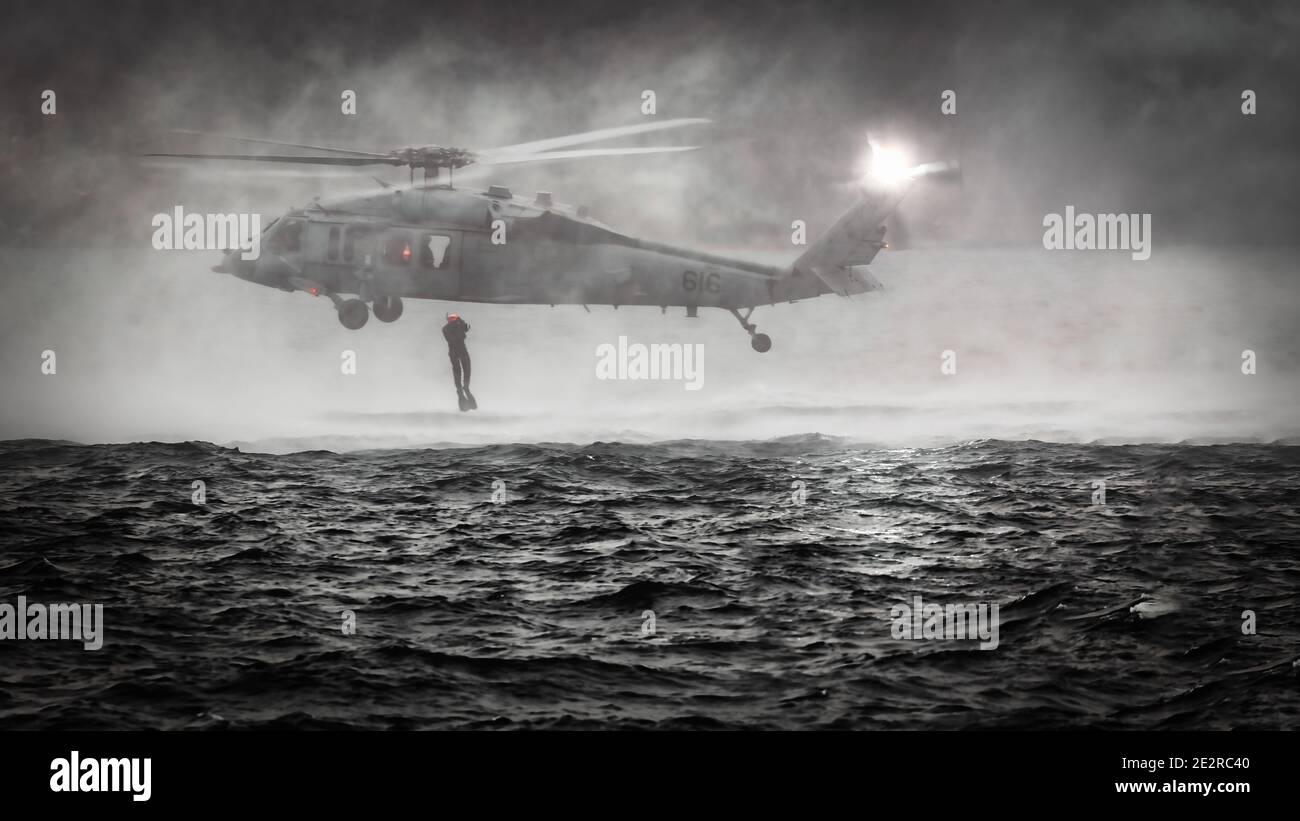 Un elicottero MH-60 della Marina degli Stati Uniti con nuotatori di soccorso pratica al largo della costa nella Baia di Tokyo. Foto Stock