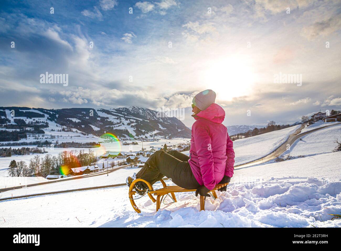 Germania, Baviera, Allgäu, Donna godendo di una giornata di slittino invernale Foto Stock