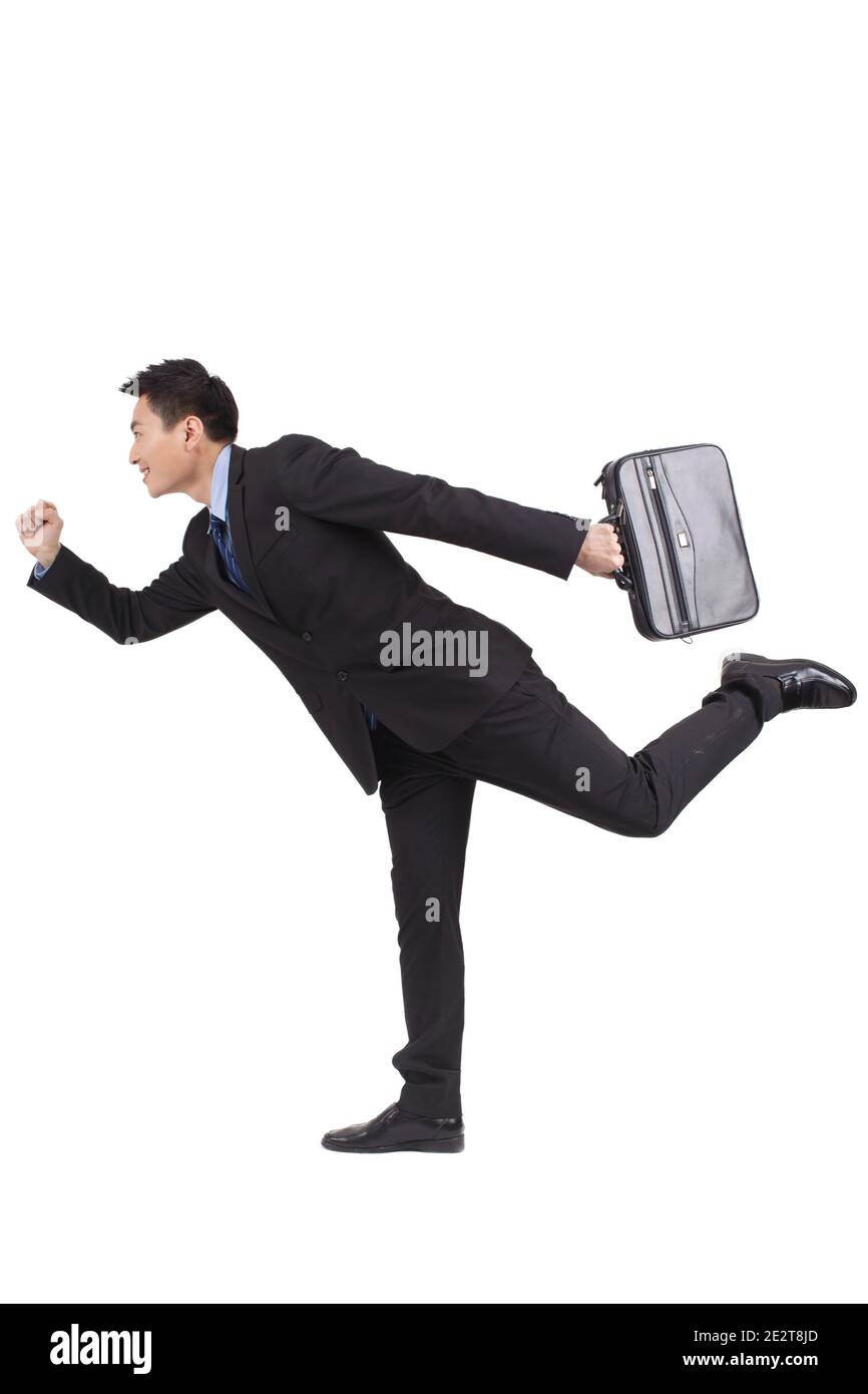 Ritratto di giovane uomo d'affari che tiene la valigetta e che corre di alta qualità foto Foto Stock
