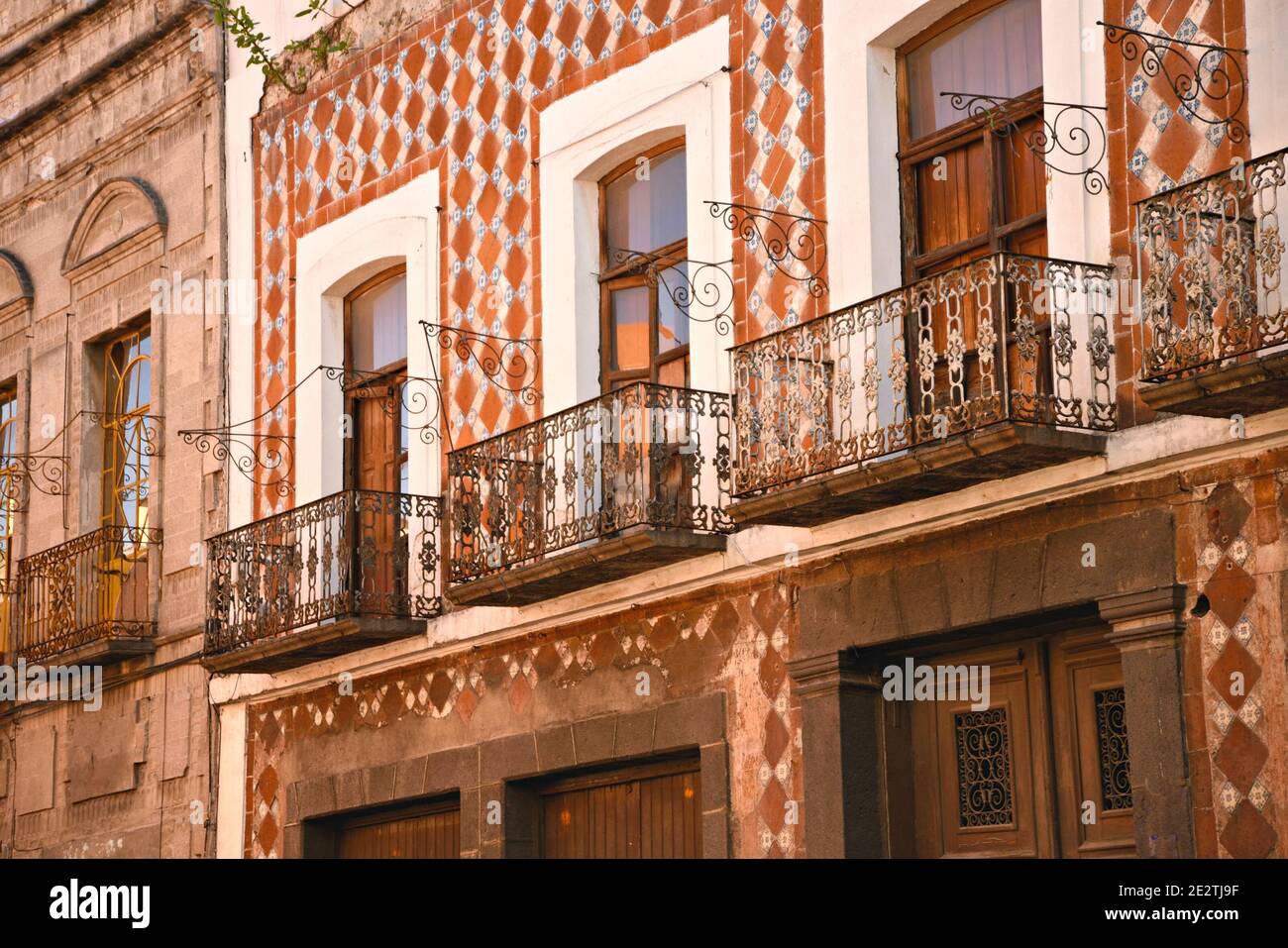 Facciata dell'edificio coloniale con decorazioni in piastrelle Talavera e ringhiere di balcone in ferro artigianali sul 5 de Mayo nel centro storico di Puebla Messico. Foto Stock