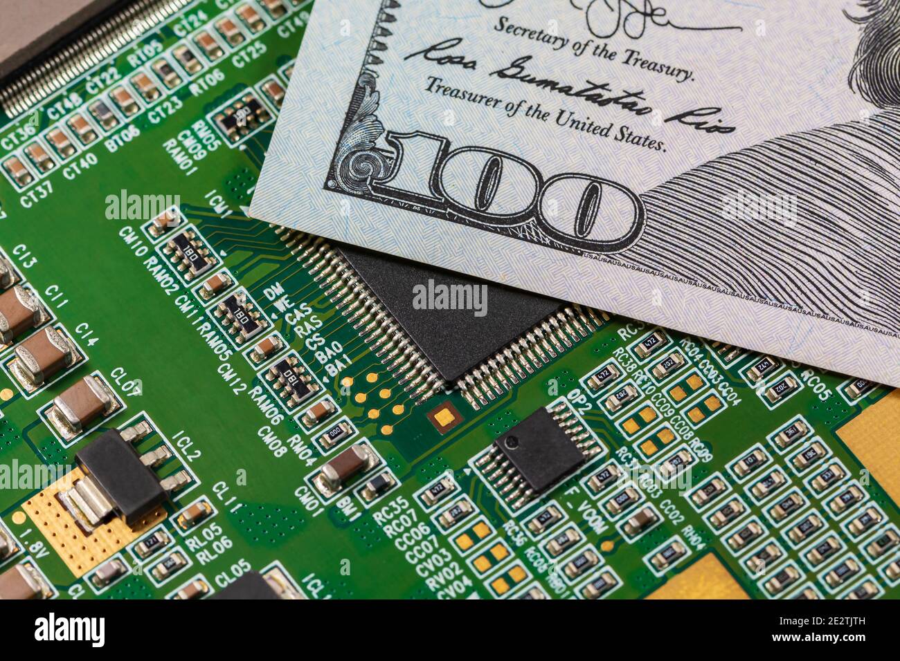 Closeup di schede a circuito stampato a semiconduttore e 100 dollari di legge. Concetto di carenza di semiconduttori, fornitura e produzione Foto Stock