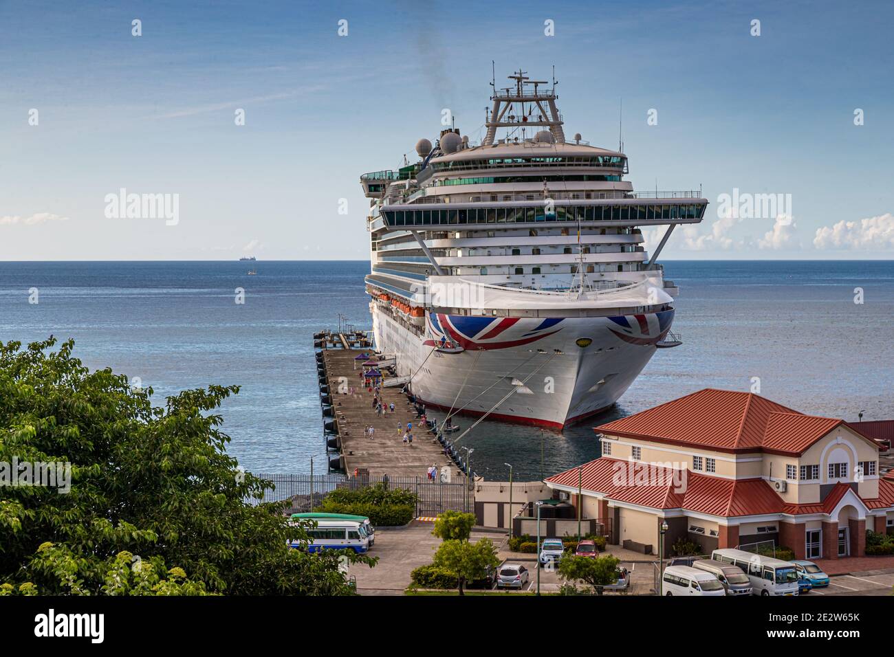 La nave da crociera P&O "Azura" è ormeggiata al terminal crociere di St. George's, la capitale della Grenada fondata nel 1650, qui vista da un punto di osservazione elevato. Gli autobus turistici attendono ai piedi della passerella. Foto Stock