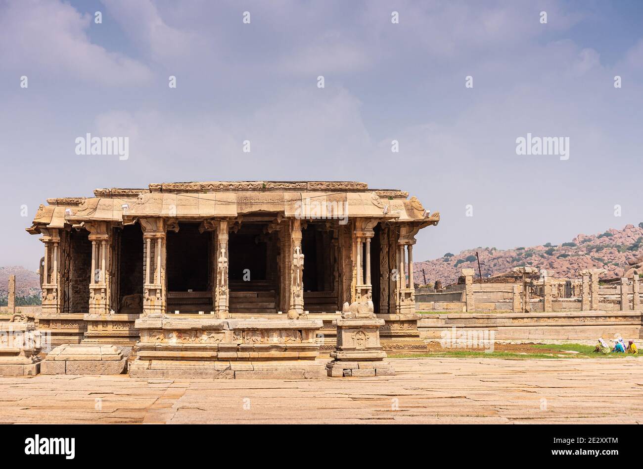 Hampi, Karnataka, India - 5 novembre 2013: Tempio Vijaya Vitthala. Abbandonata e rovinosa sala mandapam sul lato con le montagne all'orizzonte sotto il blu c. Foto Stock
