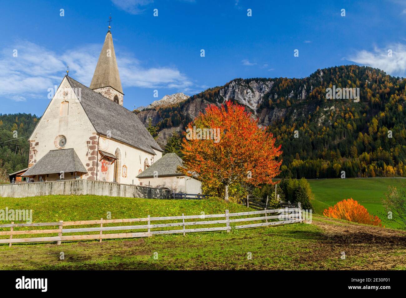 Vista della caratteristica chiesa e della città di San Magdalena. Val di Funes, Alpi Dolomiti, Trentino Alto Adige, Italia. Foto Stock