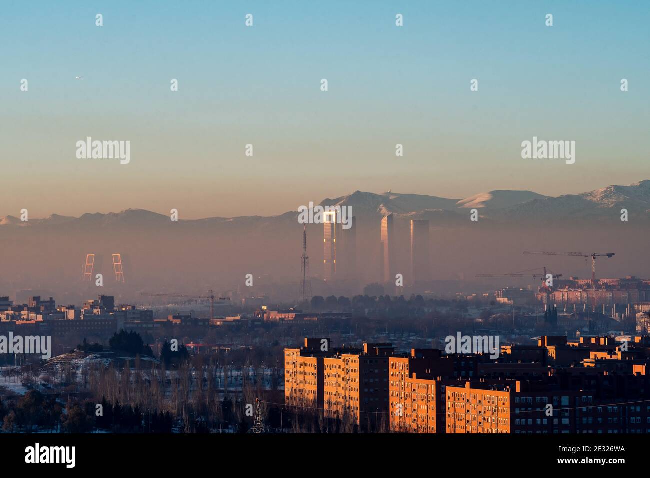 Madrid, Spagna. 16 gennaio 2021. Vista dei grattacieli della zona commerciale di Madrid con inquinamento. I livelli di inquinamento sono aumentati negli ultimi giorni dopo la tempesta di neve 'Filomena' a causa della situazione anticiclone con il tempo soleggiato, le basse temperature, l'assenza di vento e il fenomeno dell'inversione termica. Credit: Marcos del Mazo/Alamy Live News Foto Stock