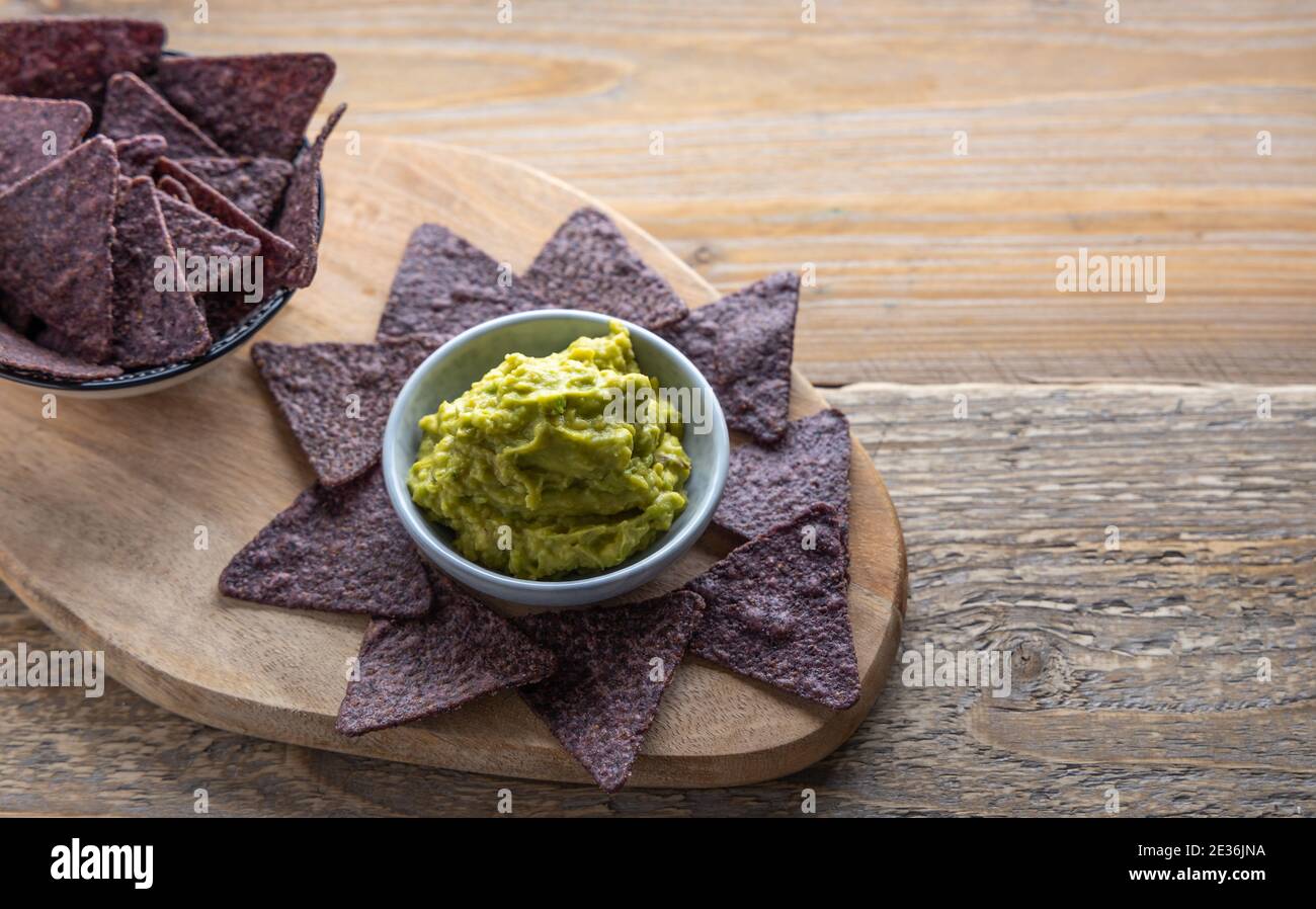Tortilla di mais blu con guacamole fatte in casa sul lato. Foto Stock