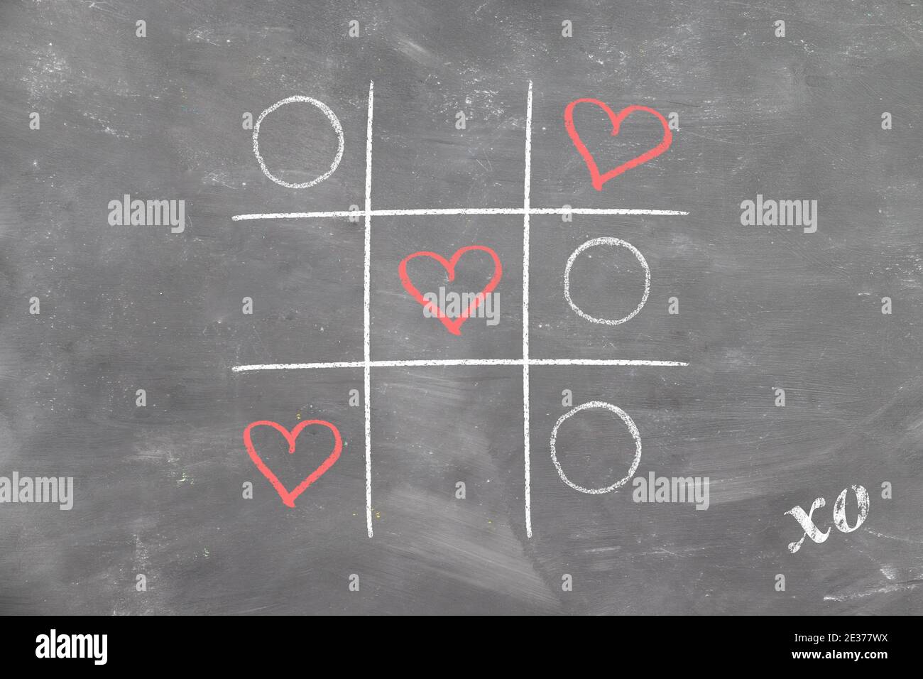 TIC-tac-TOE sulla tavola di gesso ha vinto i cuori di amore e il giorno di San Valentino firmato xo Foto Stock