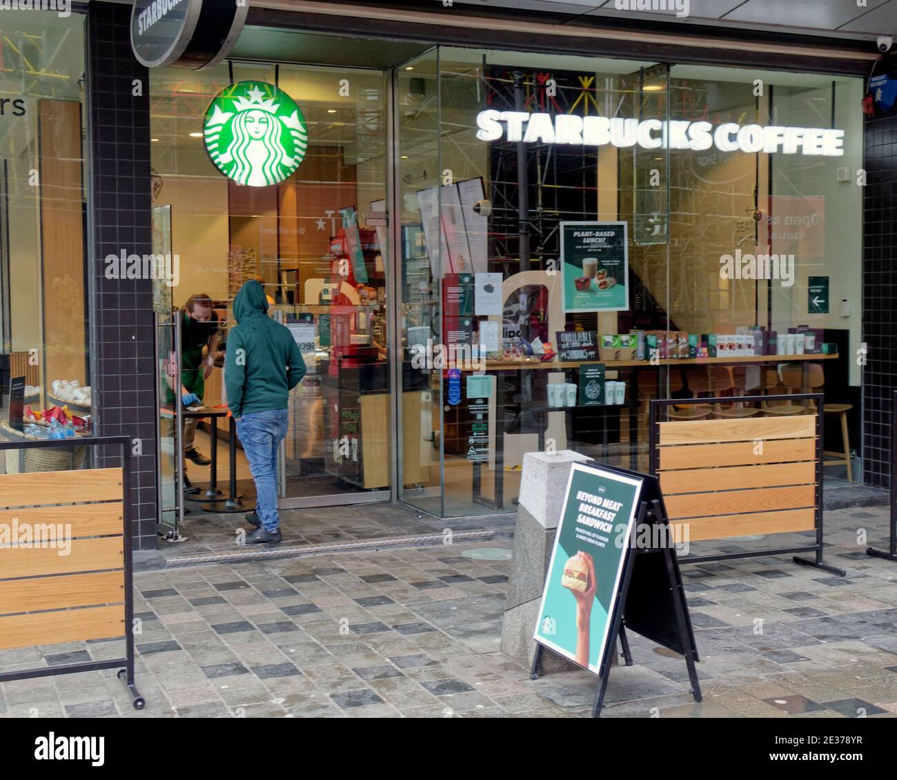 Glasgow, Scozia, Regno Unito. 17 gennaio 2021. Il caffè starbucks di Lockdown deve servire attraverso i portelli. La domenica ha visto strade scarsamente piene e persone che giravano in giro perse con le nuove regole del take-away. Credit: Gerard Ferry/Alamy Live News Foto Stock